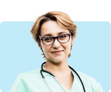 Professional woman with glasses wearing a teal medical scrubs and a stethoscope around her neck, standing against a light blue background.
