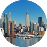 Clear daytime view of the new york city skyline featuring the empire state building and surrounding modern skyscrapers.