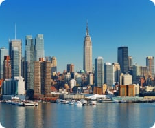 Clear daytime view of the new york city skyline featuring the empire state building and surrounding modern skyscrapers.