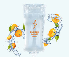 An IV bag labeled "Energy Boost Drip," surrounded by splashing water, ice cubes, and orange slices.